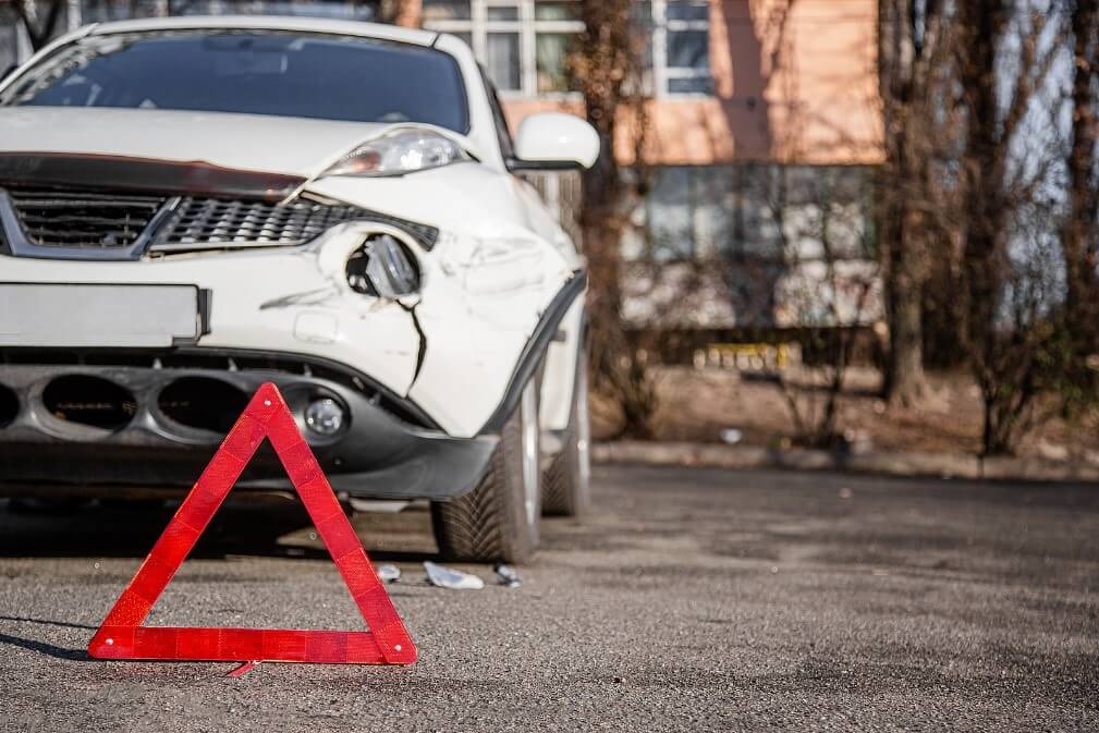 A car with a warning triangle in front of it